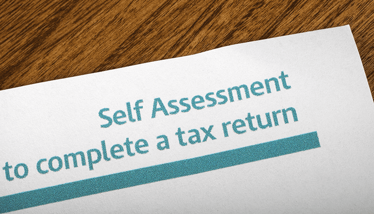 piece of paper on a desk showing the top of an HMRC self assessment tax form